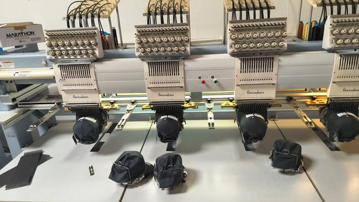 Embroidery machine stitching hats at DARTMAR